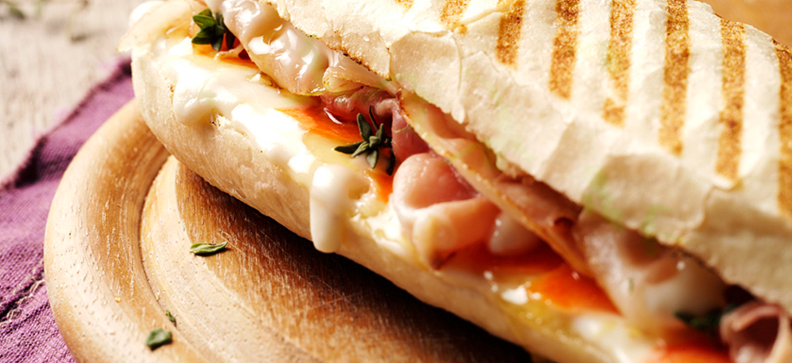 Panini au fromage de chèvre fondu, au lard, aux carottes, thym et miel