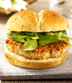Crunchy white fish burger with aged Gouda cheese and spinach