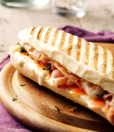 Panini with melted goat’s cheese, bacon, carrot, thyme and honey