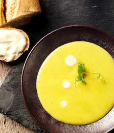 Spicy chicken curry soup with Gouda cheese