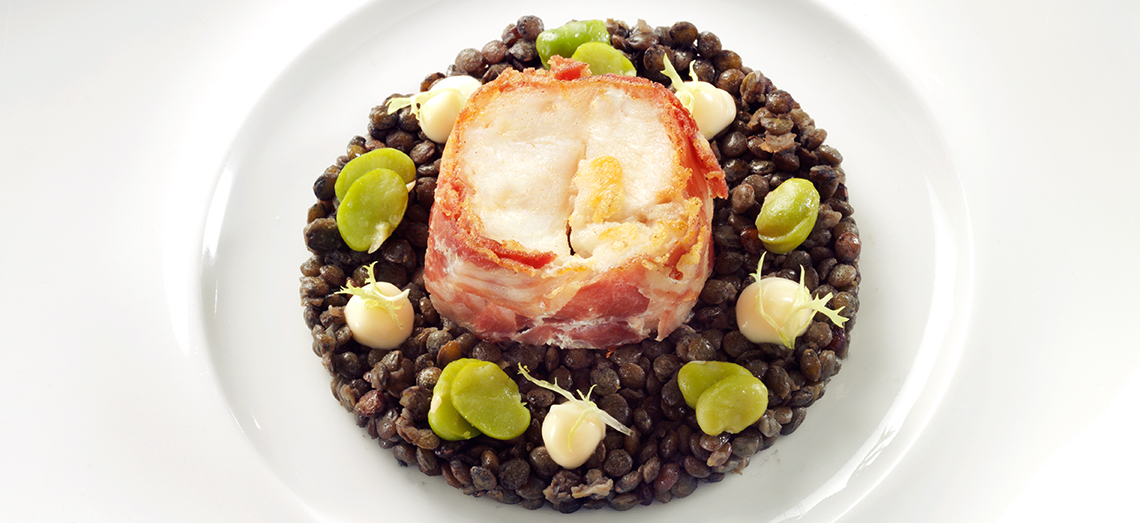 Fried catfish fillet with black lentils and a goat’s cheese topping