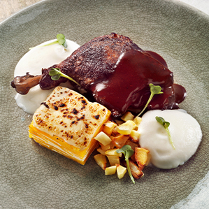 Braised duck leg with a pumpkin gratin and blue cheese