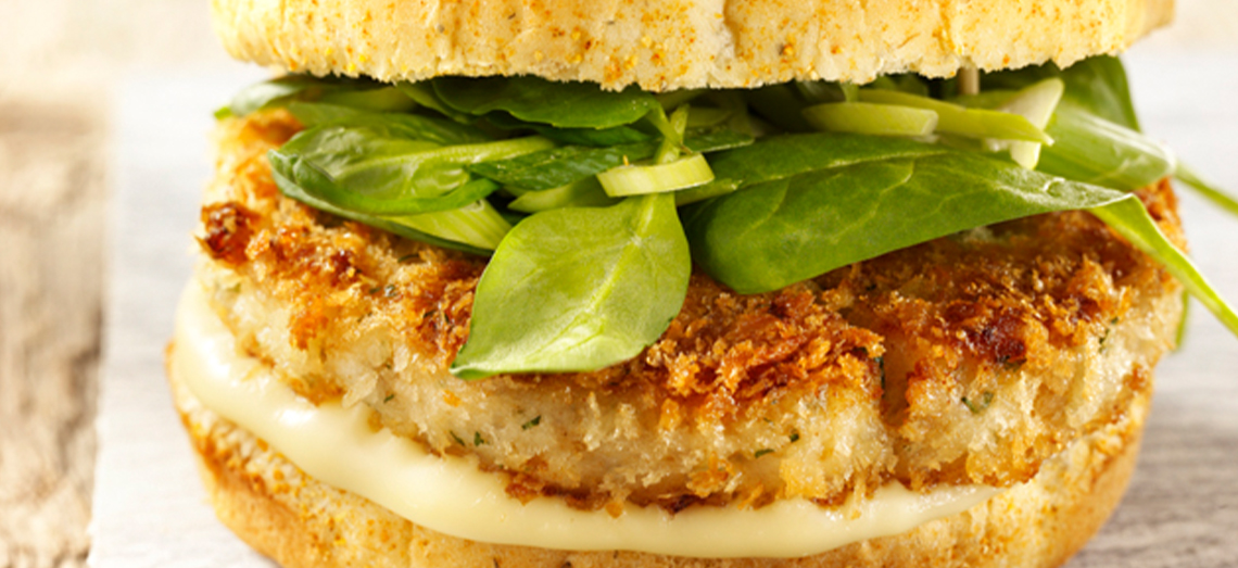 Crunchy white fish burger with aged Gouda cheese and spinach