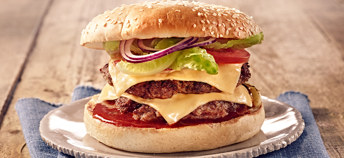Double cheeseburger with cheddar cheese, tomato and lettuce