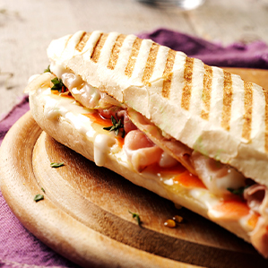 Panini with melted goat’s cheese, bacon, carrot, thyme and honey