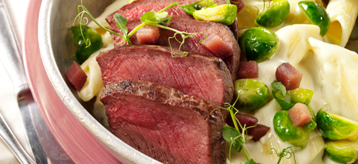 Penne with venison fillet, sprouts, stewed pear and melted blue cheese