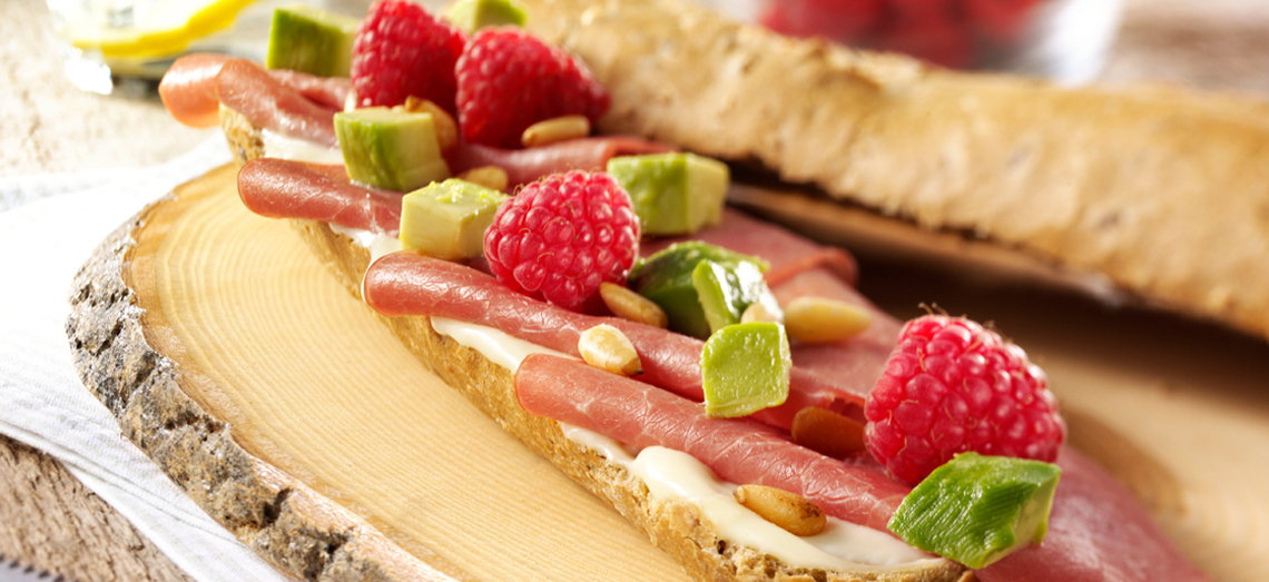 Petit pain with soft Gouda cheese, smoked meat, avocado and raspberry