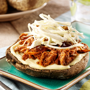 Pulled pork sandwich with melted extra aged cheese and coleslaw