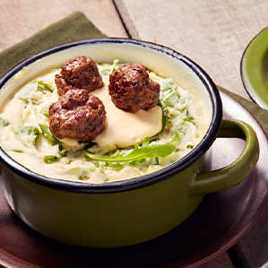 Rocket and potato stamppot with melted extra aged cheese and beef meatballs